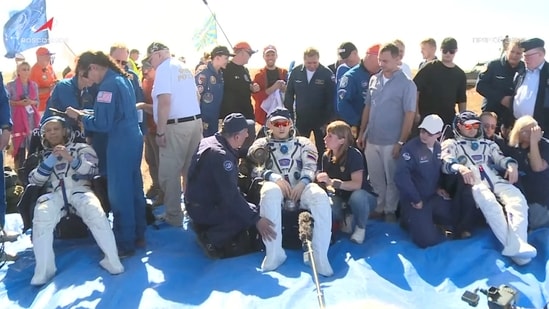 NASA astronaut Christopher Williams, Roscosmos cosmonauts Sergey Kud-Sverchkov and Sergei Mikaev rest after returning from the International Space Station (ISS) aboard the Soyuz MS-28 space capsule following their landing in a remote area near Zhezkazgan, Kazakhstan, July 26, 2026, 