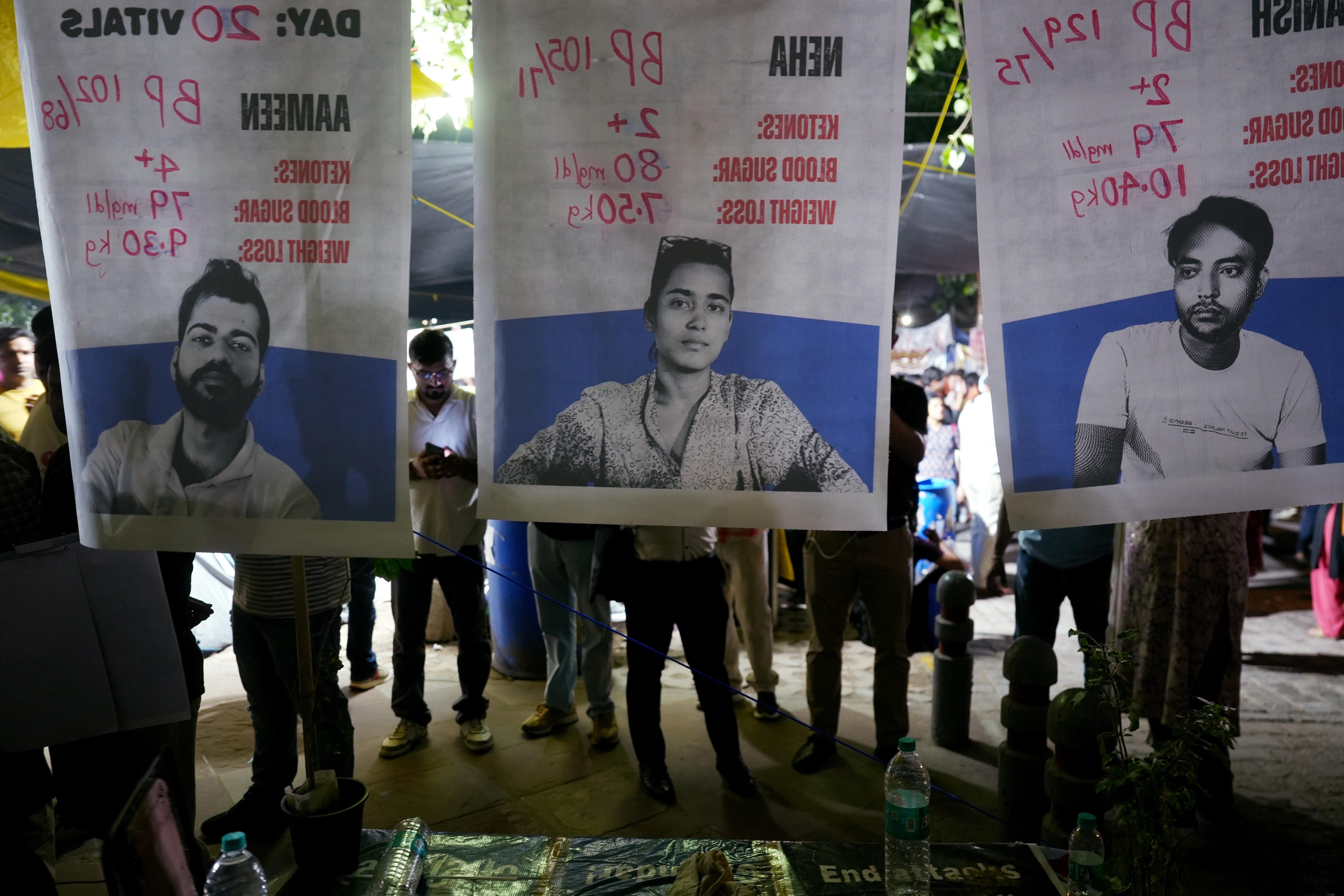 People stand near banners of AISA activists, from left, Aameen, Neha and Manish, who remained on hunger strike for over three weeks at the Jantar Mantar in New Delhi. (Karma Bhutia/PTI Photo) People stand near banners of AISA activists, from left, Aameen, Neha and Manish, who remained on hunger strike for over three weeks at the Jantar Mantar in New Delhi. (Karma Bhutia/PTI Photo)