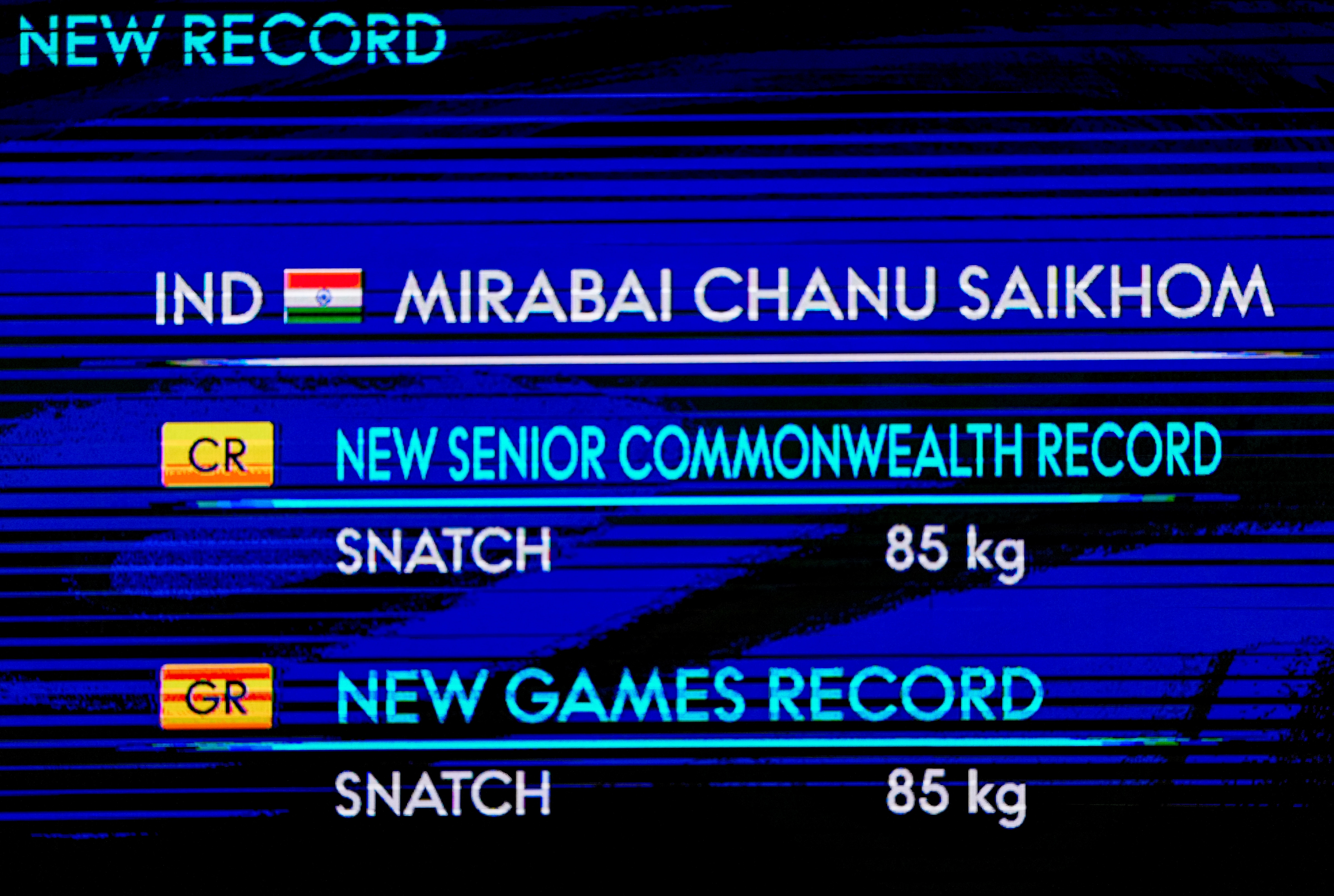 A screen shows details of India's Mirabai Chanu's Commonwealth and Games record after she lifted 85kg in snatch during the women's 48kg Final weightlifting competition (PTI) A screen shows details of India's Mirabai Chanu's Commonwealth and Games record after she lifted 85kg in snatch during the women's 48kg Final weightlifting competition (PTI)