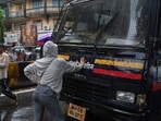 Rhiya Ahir, a model, blocks a police van carrying detained protesters during a demonstration demanding educational reforms as part of the Cockroach Janta Party's ongoing protest.