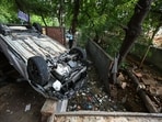 An overturned car lies near a drain after 20-year-old Yashvendra, the son of an Indian Army officer, died when the vehicle he was driving fell into the drain.