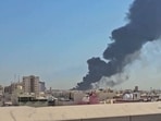 A plume of smoke billowing over the town of Mangaf, south of Kuwait City. as the Kuwait government accused Iran of targeting civilian sites and vital infrastructure in the country, after reporting attacks on an oil facility and a power and water plant. 