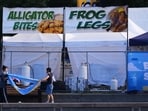 Vendors clean up the day after a shooting at Seattle Center during the Bite of Seattle food festival, Monday, July 27, 2026, in Seattle. (AP Photo/Lindsey Wasson)