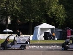 Workers clean up the day after a shooting at Seattle Center during the Bite of Seattle food festival in Seattle. 