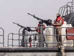 Sailors from the navy of Yemen's Aden-based internationally recognised government stand at machine-gun positions aboard a vessel patrolling a shipping lane off Hanish Island in the Red Sea on July 27, 2026.