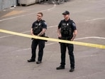 Police officers keep watch after a mass shooting at the Bite of Seattle food festival on July 26, 2026 in Seattle, Washington. 