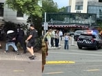 Videos showed police put a man in handcuffs amid the mass shooting at the Seattle Center on Sunday.