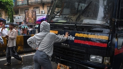 Rhiya Ahir, a model, blocks a police van carrying detained protesters during a demonstration demanding educational reforms as part of the Cockroach Janta Party's ongoing protest. (AP Photo) Rhiya Ahir, a model, blocks a police van carrying detained protesters during a demonstration demanding educational reforms as part of the Cockroach Janta Party's ongoing protest. (AP Photo)