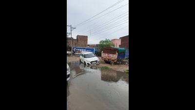 During rains, overflowing sewerage water spreads across the carriageway, making it nearly impossible to distinguish between the road surface and potholes. (HT Photo)
