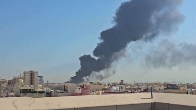A plume of smoke billowing over the town of Mangaf, south of Kuwait City. as the Kuwait government accused Iran of targeting civilian sites and vital infrastructure in the country, after reporting attacks on an oil facility and a power and water plant. (AFP (Source: UGC))