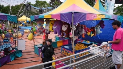 A police officer responds after a shooting at the Seattle Center during the Seattle Food Festival on Sunday, July 26, 2026, in Seattle, Washington. (AP Photo)