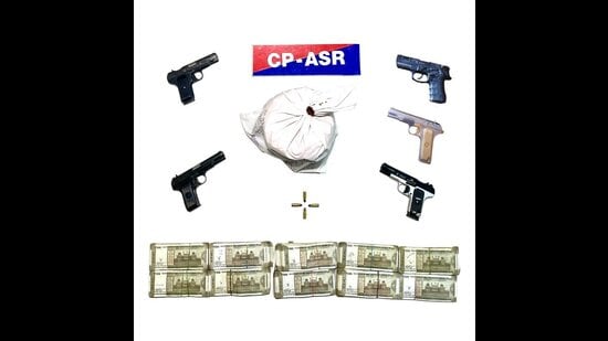 Amritsar police recovered five sophisticated .30-bore pistols, 2.015 kg heroin and  <span class='webrupee'>₹</span>5 lakh in drug money. (HT)