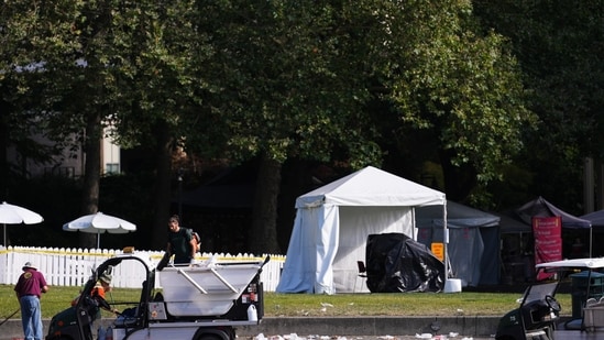 Workers clean up the day after a shooting at Seattle Center during the Bite of Seattle food festival in Seattle. 