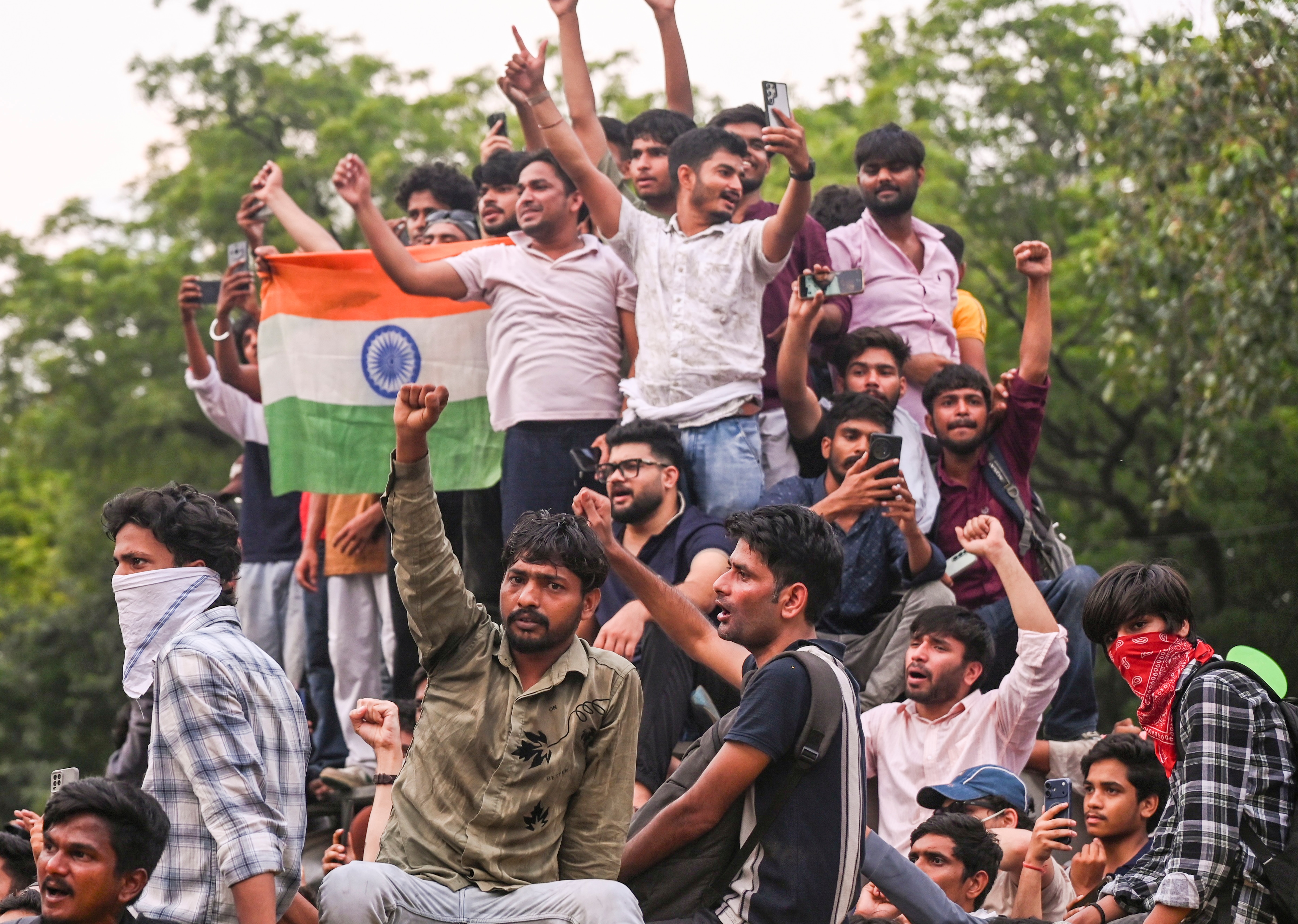 Cockroach Janta Party (CJP) supporters celebrate after Union Education Minister Dharmendra Pradhan resigned and took responsibility for the NEET paper leak, at Jantar Mantar in New Delhi, Saturday, July 25, 2026. (PTI)