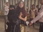 Videos shared online show the woman protesting her husband's second marriage. 