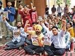 Employees of Aam Aadmi Clinics raising slogans during a protest outside the civil surgeon office in Amritsar on Monday. (Sameer Sehgal/HT)
