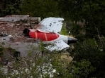 Tail of Air India Boeing 787 Dreamliner plane that crashed is seen stuck on a building after the incident in Ahmedabad.