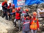 Personnel of the Jammu and Kashmir Police (JKP) Mountain Rescue Team (MRT) carry a pilgrim on a stretcher while providing assistance along the Baltal route during the annual Amarnath Yatra, on Monday. (PTI)