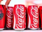 Coca-Cola beats earnings as World Cup sales boost revenue, raises 2026 forecast, while Fairlife resumes production after ransomware cyberattack. (Photo by Patrick T. Fallon / AFP)