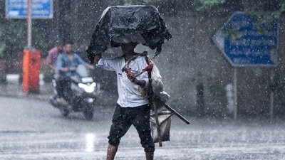 A man crosses road amid heavy rainfall, in New Delhi. (ANI) A man crosses road amid heavy rainfall, in New Delhi. (ANI)