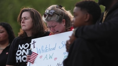 Michelle Whitehead, center, cousin of Ashley Whitehead, one of the victims, attends the vigil for the victims. (AP Photo/Lindsey Wasson)