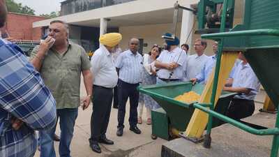 Officials during maize dryer demonstration at Punjab Agricultural University in Ludhiana. (HT Photo)