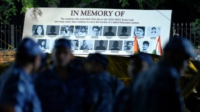 A banner shows photographs of students who allegedly took their lives following the NEET-UG 2026 paper leak, during a protest at Jantar Mantar in New Delhi. (PTI)