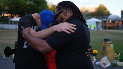 Group of dads who lost children due to gun violence praying before the vigil for victims. (AP Photo/Lindsey Wasson)