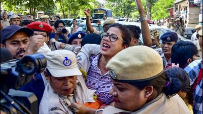 Security personnel detain demonstrators during the NEET protests in Guwahati on July 25. (PTI)