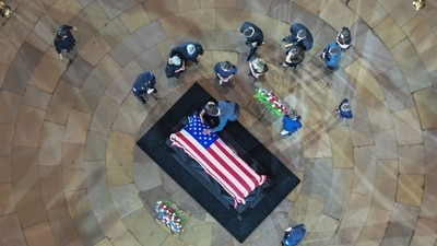 Attendees pay their respects at the casket during a Congressional tribute to late US Senator Lindsey Graham in the Rotunda of the US Capitol in Washington, DC, on July 28, 2026. Graham, a South Carolina Republican and key Trump ally who was elected to the Senate four times, died at age 71 on July 11. (Photo by Kenny HOLSTON / POOL / AFP) (AFP) Attendees pay their respects at the casket during a Congressional tribute to late US Senator Lindsey Graham in the Rotunda of the US Capitol in Washington, DC, on July 28, 2026. Graham, a South Carolina Republican and key Trump ally who was elected to the Senate four times, died at age 71 on July 11. (Photo by Kenny HOLSTON / POOL / AFP) (AFP)