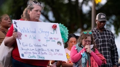 Jeanne Marie Johnson (2R) reacts during a vigil a day after the Bite of Seattle food festival shooting at Seattle Center. &nbsp; (David Ryder/Getty Images/AFP)