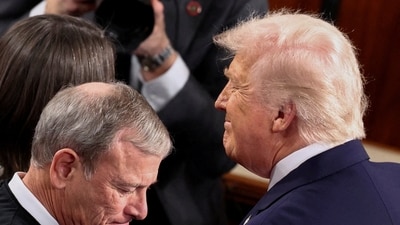 US President Donald Trump, next to Supreme Court Chief Justice John Roberts, arrives to deliver the State of the Union address to a joint session of Congress in the House Chamber at the Capitol on February 2. (REUTERS)