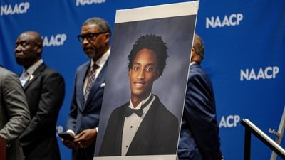 A photo of Nolan Wells is displayed on stage where Ben Crump, a lawyer for the family of Nolan Wells announces the results of an independent autopsy on July 22. (REUTERS)