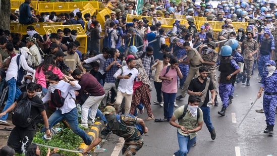 Security personnel carry out a lathi charge during the CJP protest march near the Parliament in New Delhi, India, on Monday, July 20, 2026.  