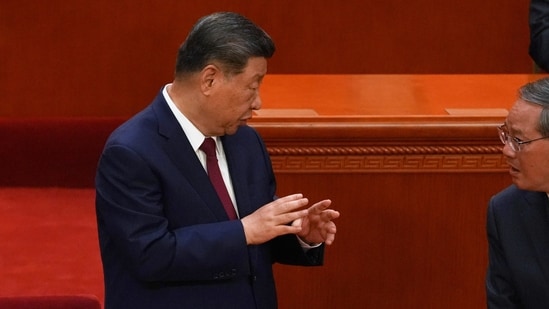 Chinese President Xi Jinping, left, gestures to Chinese Premier Li Qiang during a ceremony to mark the 105th anniversary of the founding of the Chinese Communist Party at the Great Hall of the People in Beijing, Wednesday, July 1, 2026. (AP Photo/Ng Han Guan)