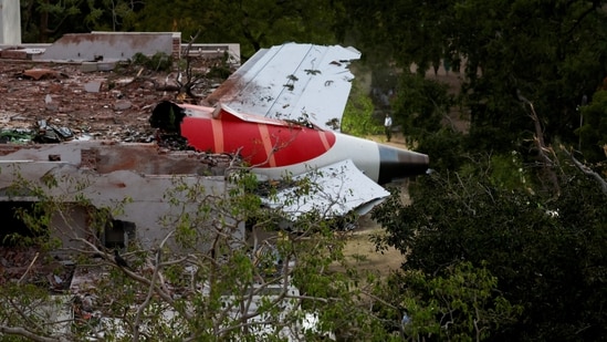 Tail of Air India Boeing 787 Dreamliner plane that crashed is seen stuck on a building after the incident in Ahmedabad.