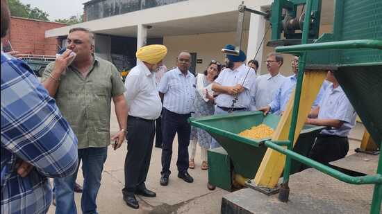Officials during maize dryer demonstration at Punjab Agricultural University in Ludhiana. (HT Photo)