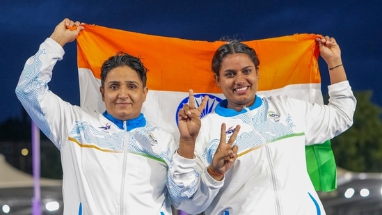 Sharmila Dhankar, left, and Shilpa K Shyla celebrate after winning gold and bronze medals respectively in the women's shot put F57.