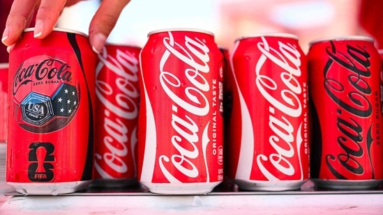 Coca-Cola beats earnings as World Cup sales boost revenue, raises 2026 forecast, while Fairlife resumes production after ransomware cyberattack. (Photo by Patrick T. Fallon / AFP)