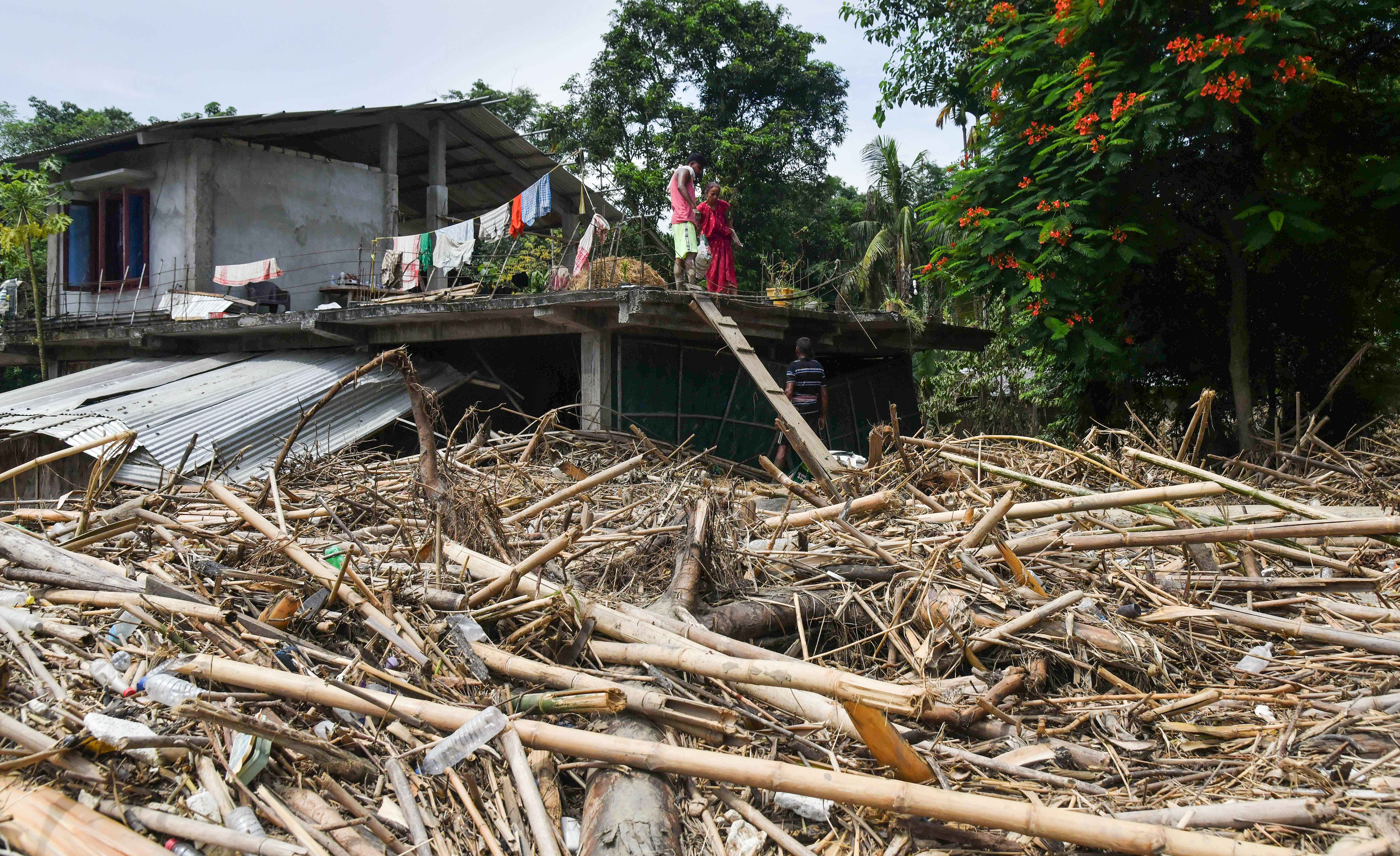 Debris, pointing toward the destruction left behind by powerful floodwaters, in Sivasagar on Sunday. (File Photo/ANI)