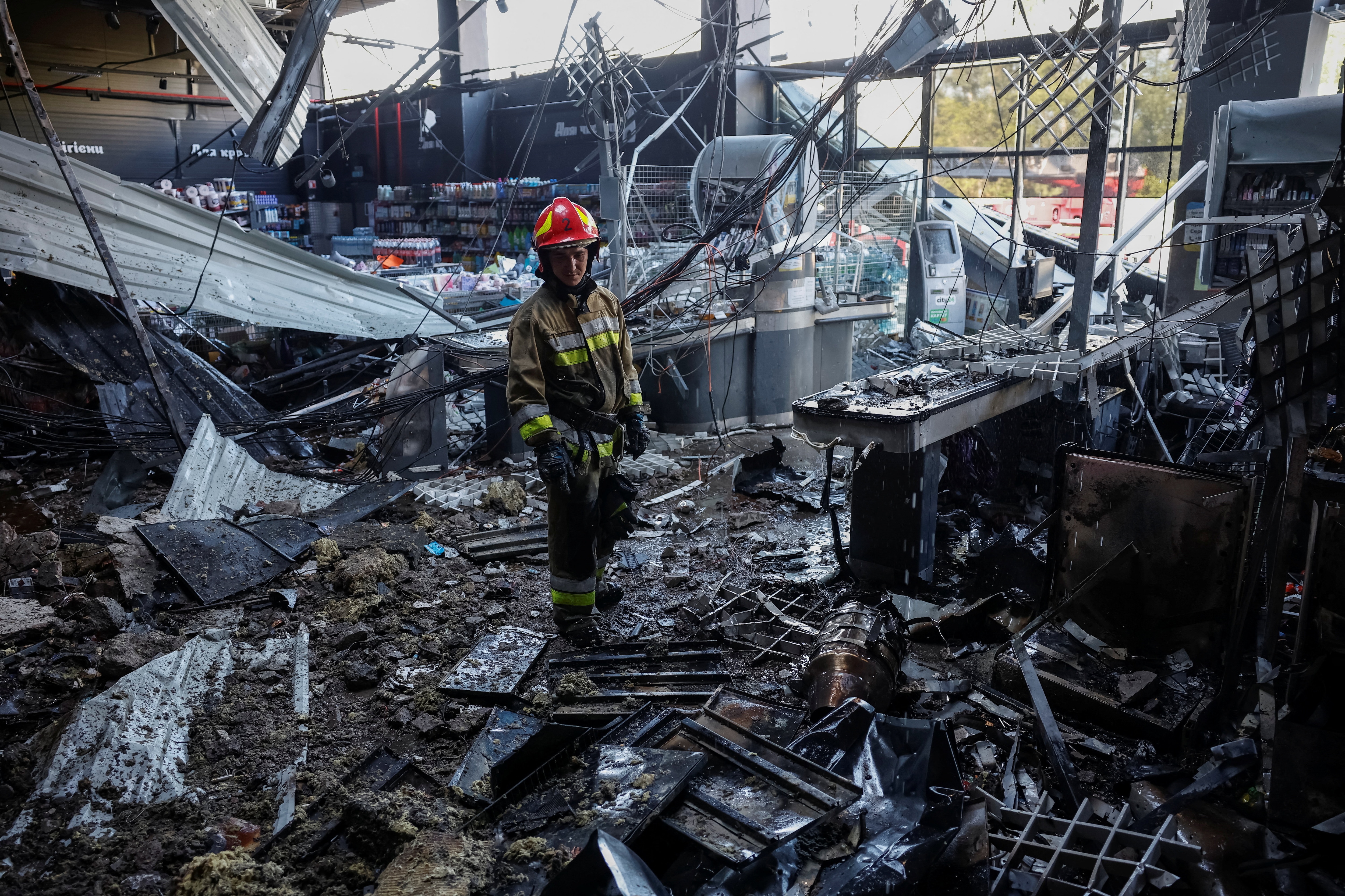 A firefighter inspects the site of a supermarket hit by a Russian drone strike, amid Russia's attack on Ukraine, in Chernihiv, Ukraine. (REUTERS)