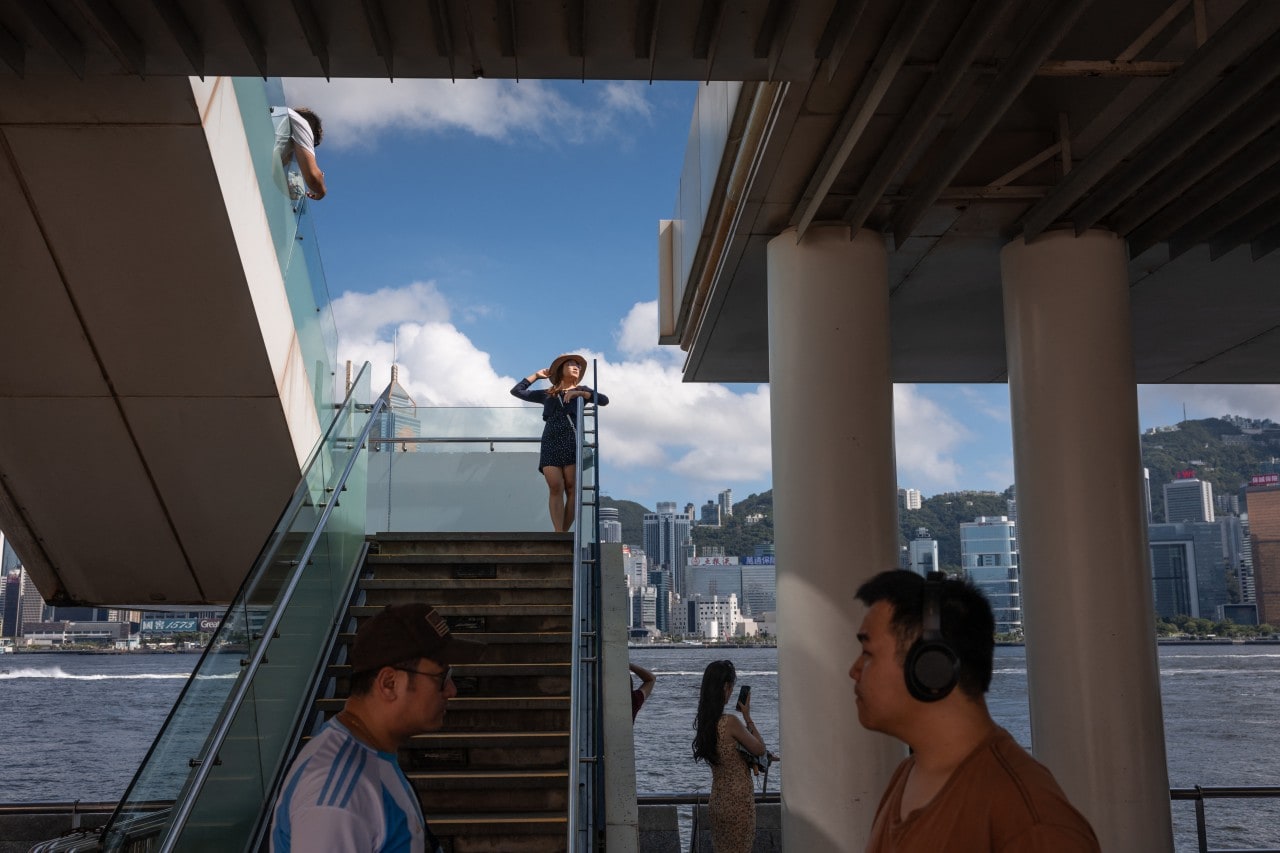 Tourists from mainland China visit a promenade along Victoria Harbour in Hong Kong.
