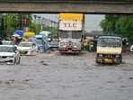 Vehicles wade through a waterlogged stretch during rain. (Parveen Kumar/HT)