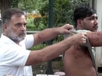 Congress leader Rahul Gandhi with a man who suffered pellet injuries at the CJP's Parliament march on July 20.