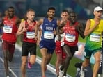 Gulveer Singh of India (blue) competes in the men's 10,000 meters final at the Commonwealth Games in Glasgow, Scotland, Tuesday. (AP Photo/Eranga Jayawardena)