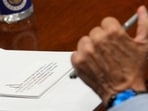 A note lies on a table in front of Anthony Fauci, the former Director of the National Institute of Allergy and Infectious Diseases (NIAID) and medical advisor to several US presidents.