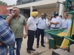Officials during maize dryer demonstration at Punjab Agricultural University in Ludhiana. (HT Photo)