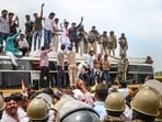 Farmers climb atop a bus as they stage a protest to press for various demands, including 100 per cent moong procurement at MSP, in Bhopal, Madhya Pradesh, Wednesday.(PTI Photo)