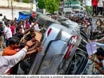 Protesters vandalising a vehicle during a protest over alleged irregularities in the NEET examination, in Prayagraj, on July 25. (PTI Photo)