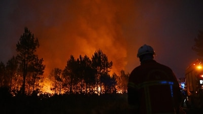 Firefighters battle a blaze outside Lanton, during wildfires in southwestern France. (AP) Firefighters battle a blaze outside Lanton, during wildfires in southwestern France. (AP)